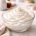 Keto Whipped Cream That’s Smooth, Light, and Foolproof 2 keto whipped cream in a glass bowl with soft peaks from a side angle